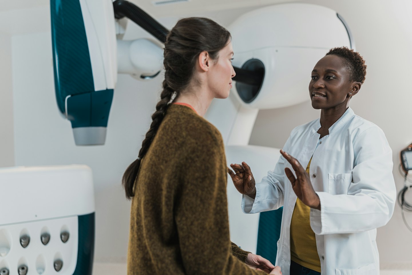 Doctor explaining a medical procedure to a patient in a clinic.